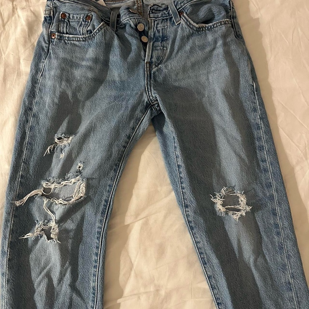 Levi 501 tapered ripped jeans